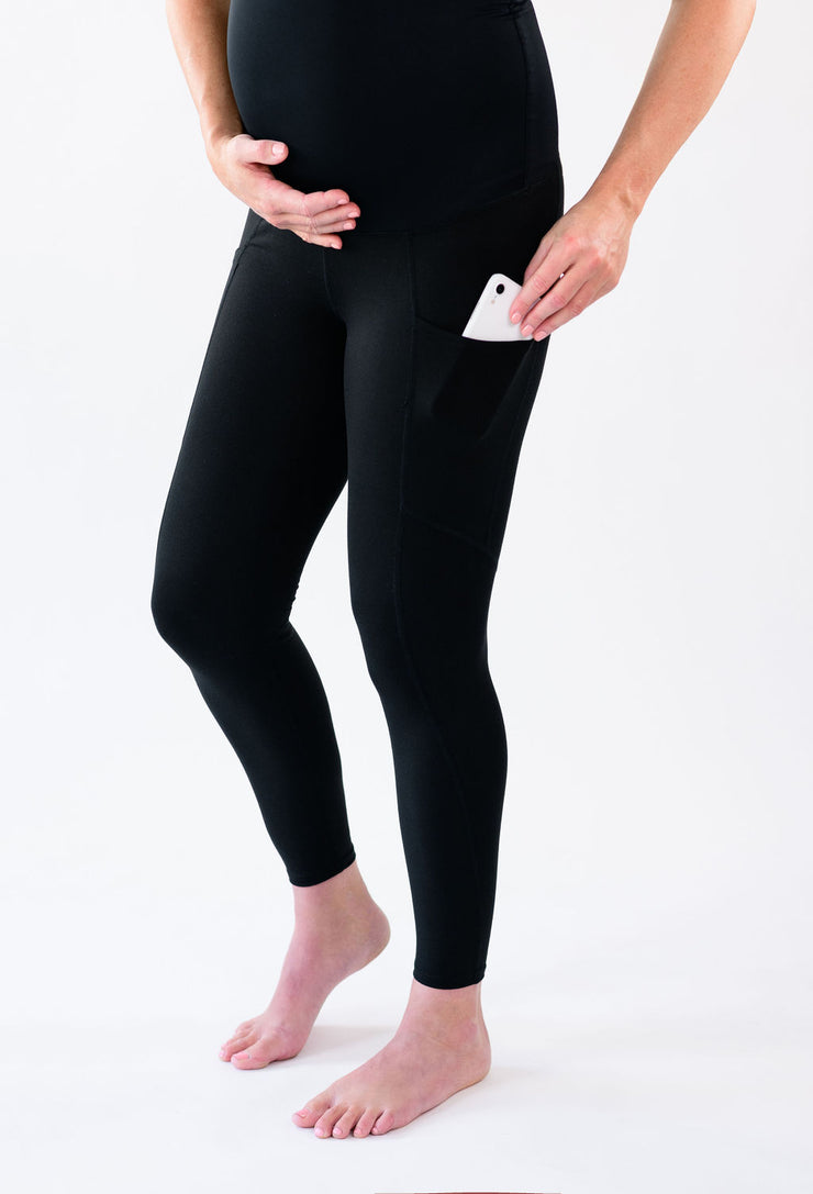 Our over-the-belly maternity leggings with pockets gives bump coverage and extra- support for working out in comfortable stretch fabric in black.